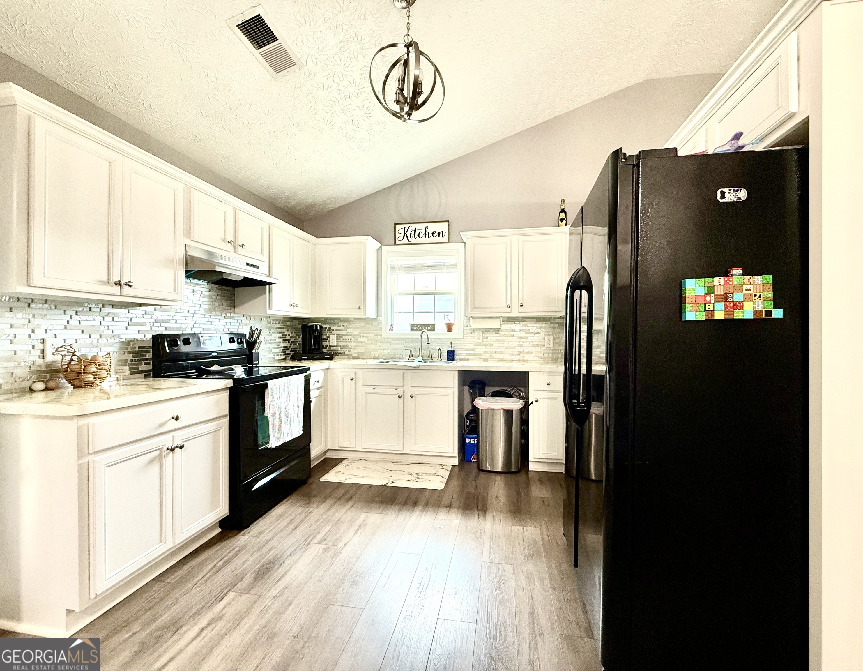 110 Waterloo Drive Mount Airy, GA 30563 - Photo 6 of 24 a kitchen with a refrigerator and cabinets
