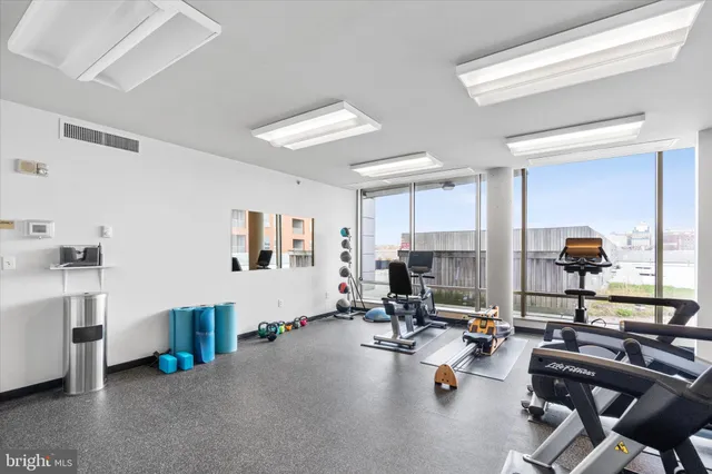a room with gym equipment and a large window