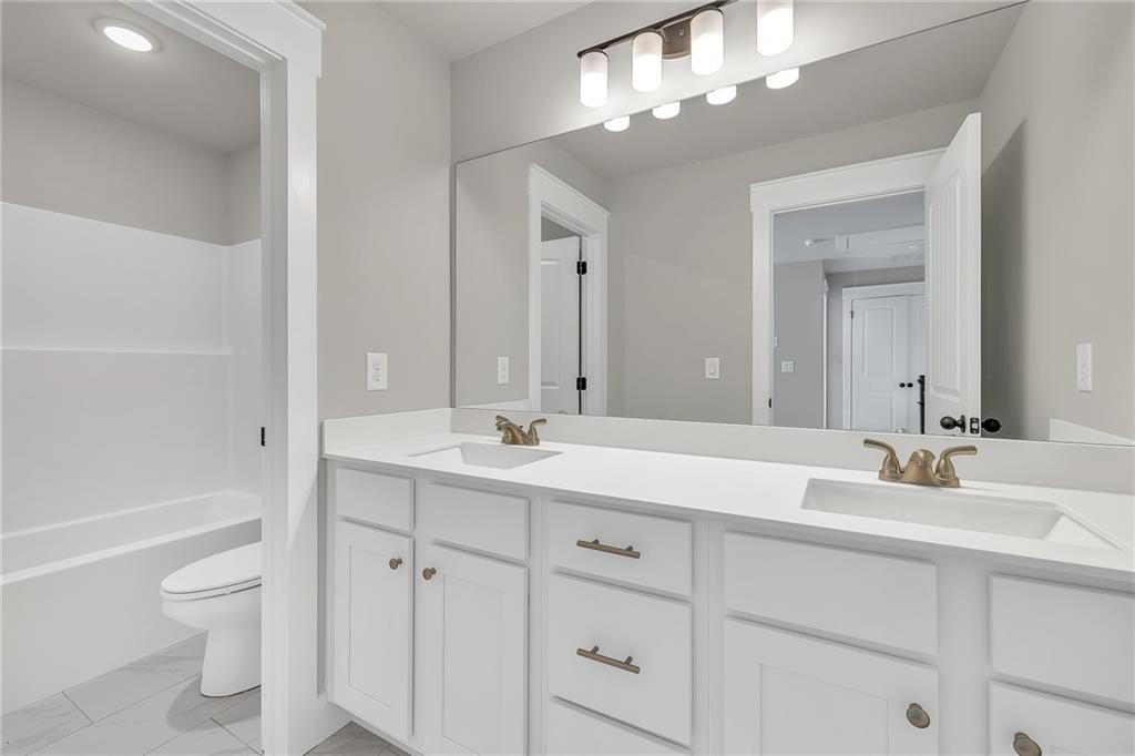 231 East Marable Street Monroe, GA 30655 - Photo 25 of 36 a bathroom with a sink a toilet and bathtub