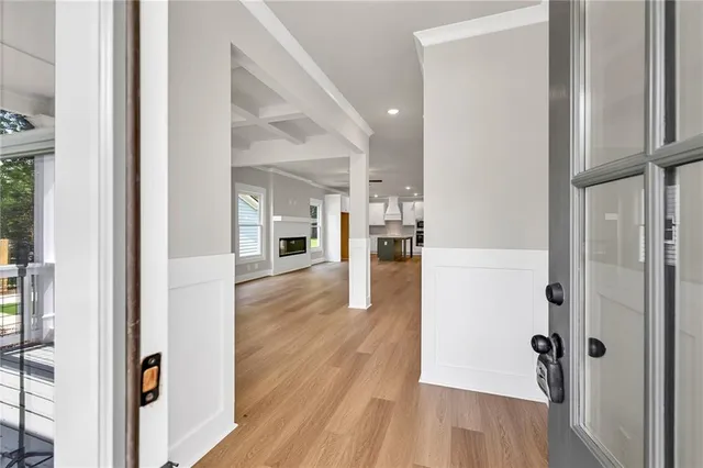 a view of a hallway with wooden floor