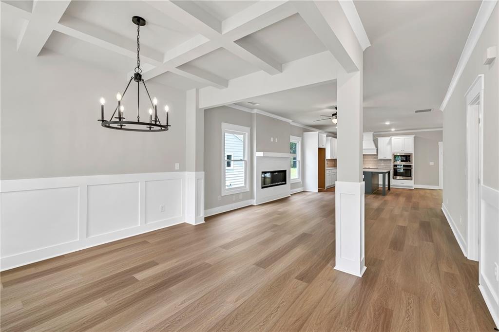 231 East Marable Street Monroe, GA 30655 - Photo 4 of 36 a view of a room with wooden floor kitchen view and a window