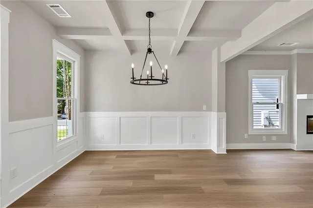a view of a room with wooden floor fan and windows