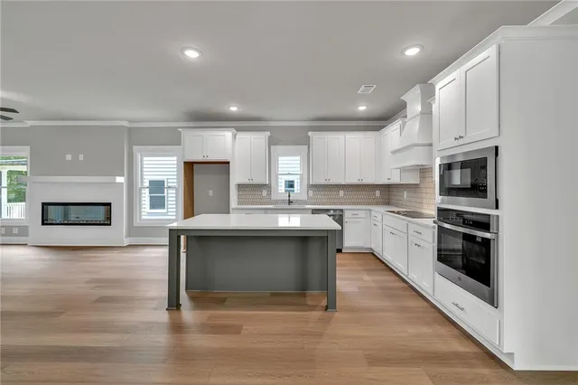 a kitchen with a refrigerator and a stove top oven