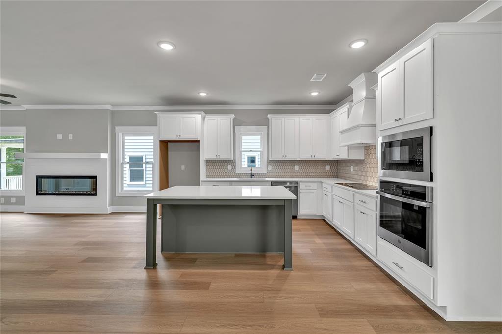 231 East Marable Street Monroe, GA 30655 - Photo 6 of 36 a kitchen with a refrigerator and a stove top oven