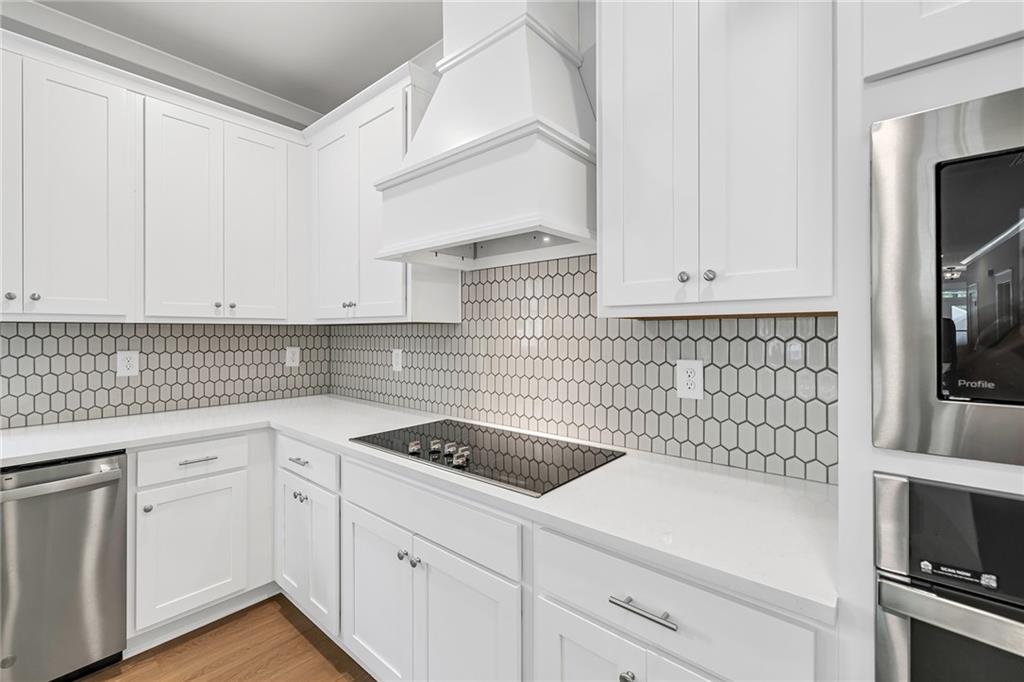 231 East Marable Street Monroe, GA 30655 - Photo 7 of 36 a kitchen with white cabinets and appliances