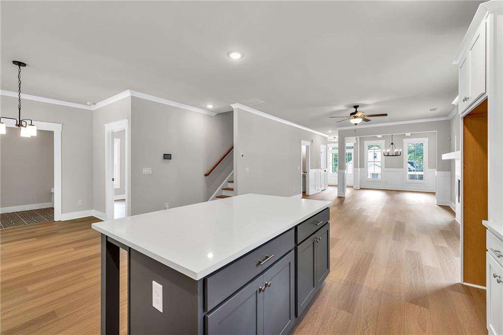 231 East Marable Street Monroe, GA 30655 - Photo 9 of 36 a kitchen with a wooden floor and window