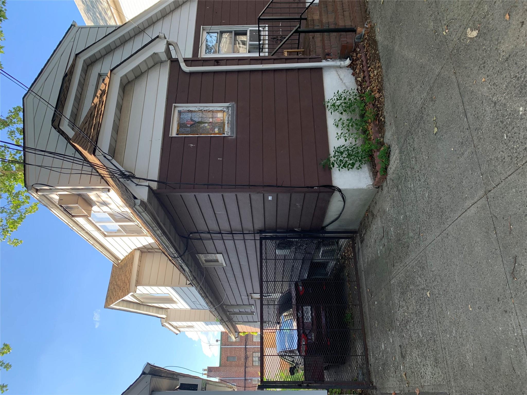 152-05 79th Avenue Queens, NY 11367 - Photo 2 of 8 View of property exterior with a gate