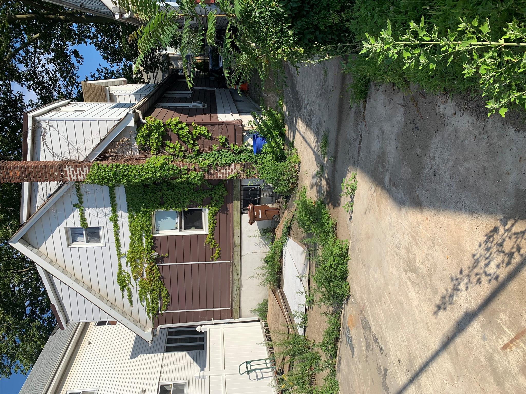 152-05 79th Avenue Queens, NY 11367 - Photo 4 of 8 View of side of home featuring a chimney and a patio area