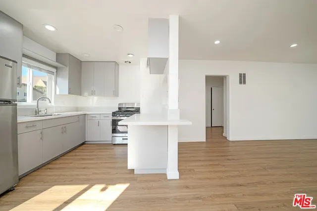 a kitchen with a sink cabinets and window