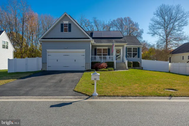 a front view of a house with a yard garage and outdoor seating