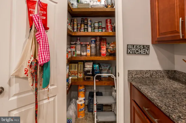 a large kitchen with stainless steel appliances granite countertop a sink a table and chairs