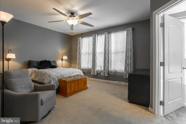 a spacious bedroom with a bed and a couch