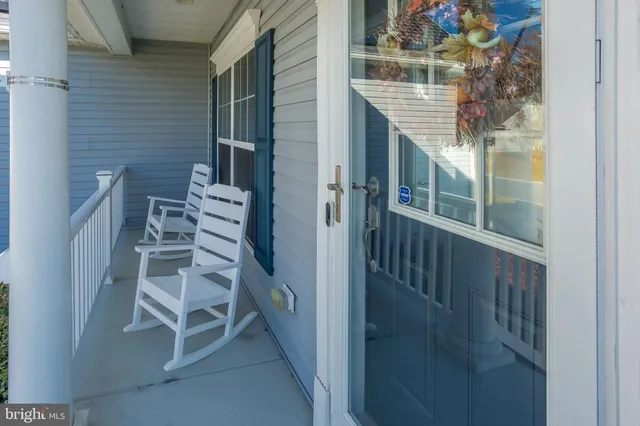 a view of a balcony with wooden chairs