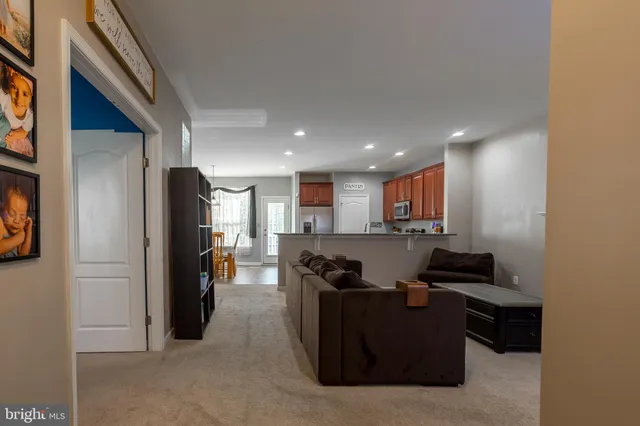 a living room with stainless steel appliances kitchen island furniture and a window