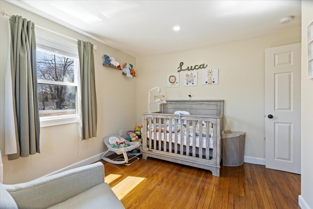 19 Warren Avenue Saugus, MA 01906 - Photo 14 of 33 a bedroom with a bed and wooden floor