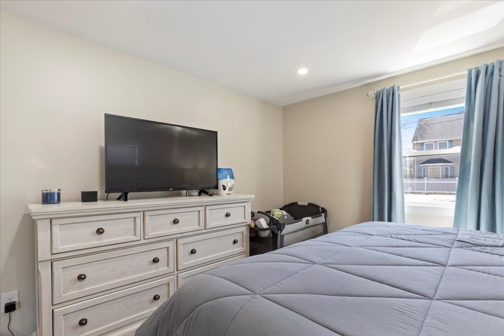 19 Warren Avenue Saugus, MA 01906 - Photo 16 of 33 a bedroom with a bed and a flat screen tv