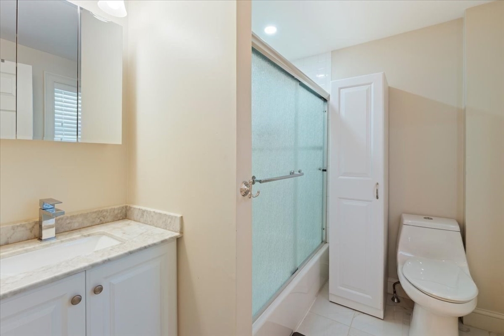 19 Warren Avenue Saugus, MA 01906 - Photo 18 of 33 a bathroom with a granite countertop sink toilet and shower