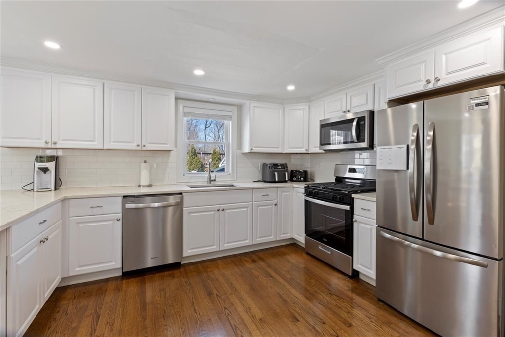 19 Warren Avenue Saugus, MA 01906 - Photo 3 of 33 a kitchen with granite countertop white cabinets and stainless steel appliances
