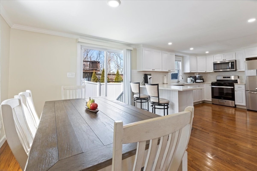 19 Warren Avenue Saugus, MA 01906 - Photo 6 of 33 a living room with stainless steel appliances furniture wooden floor and a kitchen view