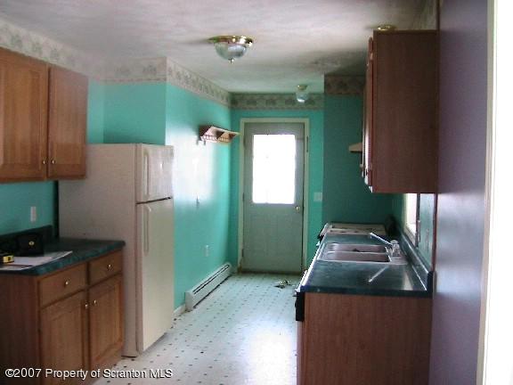 222 Cemetery Road Lake Ariel, PA 18436 - Photo 4 of 4 a kitchen with a refrigerator sink and stove