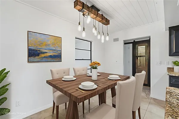 a view of a dining room with furniture and chandelier