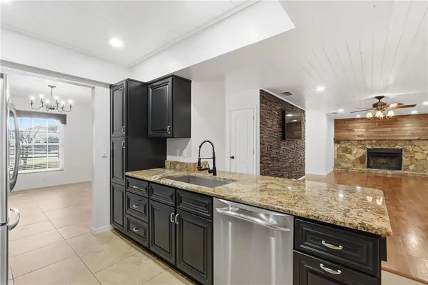 a kitchen with stainless steel appliances granite countertop a sink and a stove