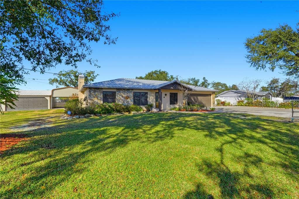 5309 South Farkas Road Plant City, FL 33567 - Photo 2 of 43 a front view of a house with a garden