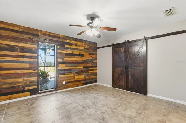 a view of an empty room with cabinet and a window