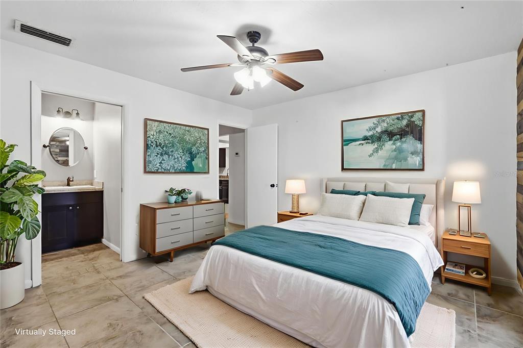 5309 South Farkas Road Plant City, FL 33567 - Photo 25 of 43 a spacious bedroom with a bed and a chandelier