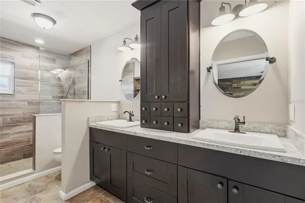 a bathroom with a double vanity sink and a mirror