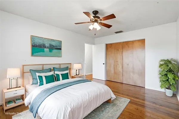 a bedroom with a bed and a potted plant