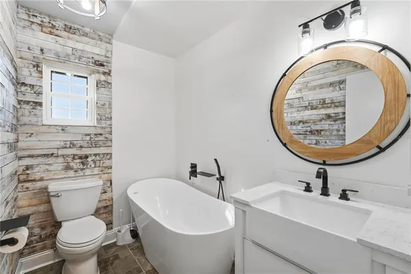 a bathroom with a toilet a sink and a mirror