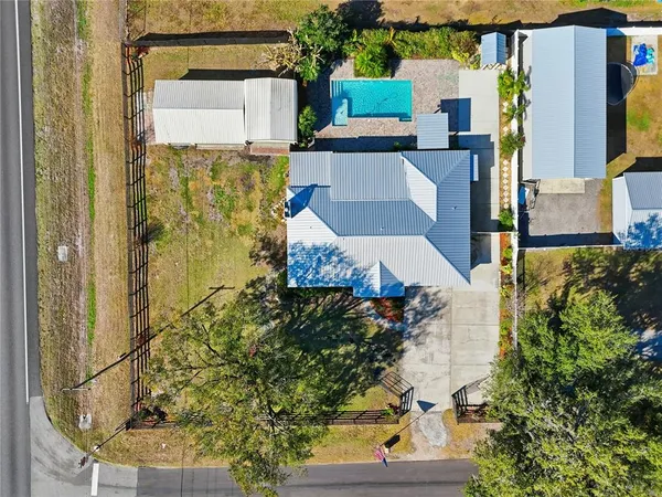 aerial view of a house with a yard and large tree