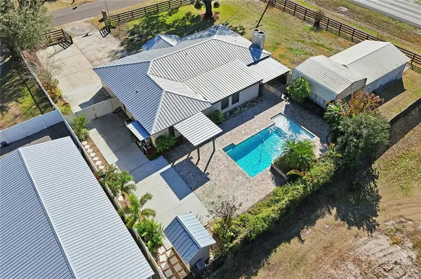 an aerial view of house with yard