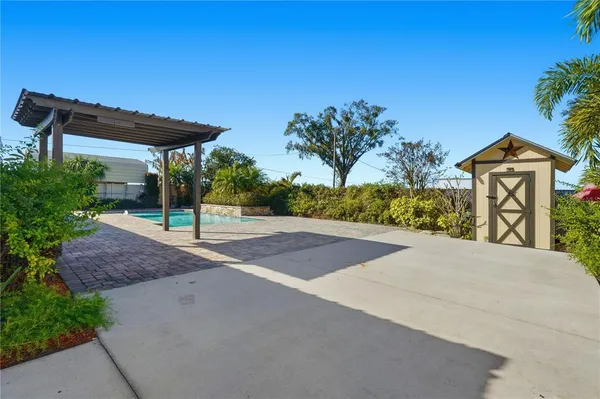 a view of a house with a yard and potted plants