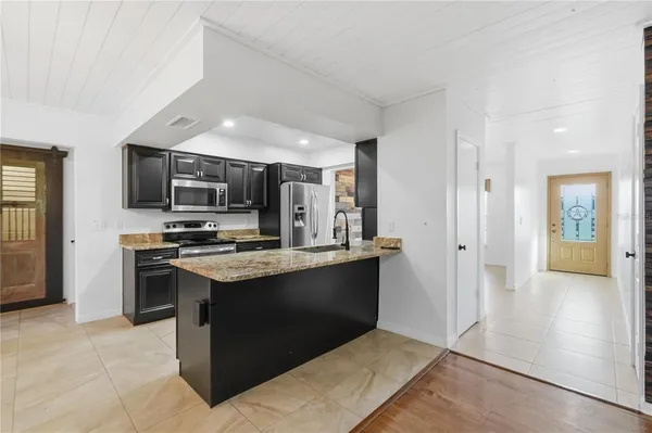 a kitchen with stainless steel appliances granite countertop a stove and a sink