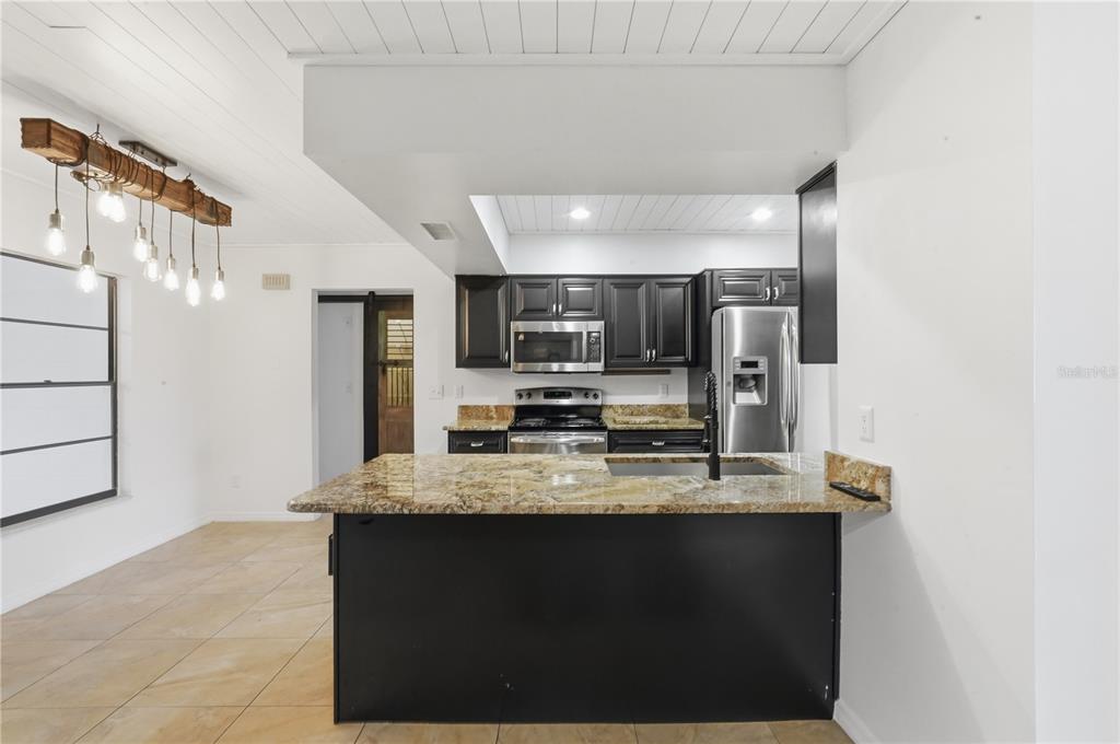 5309 South Farkas Road Plant City, FL 33567 - Photo 10 of 43 a large kitchen with a large counter top appliances and cabinets