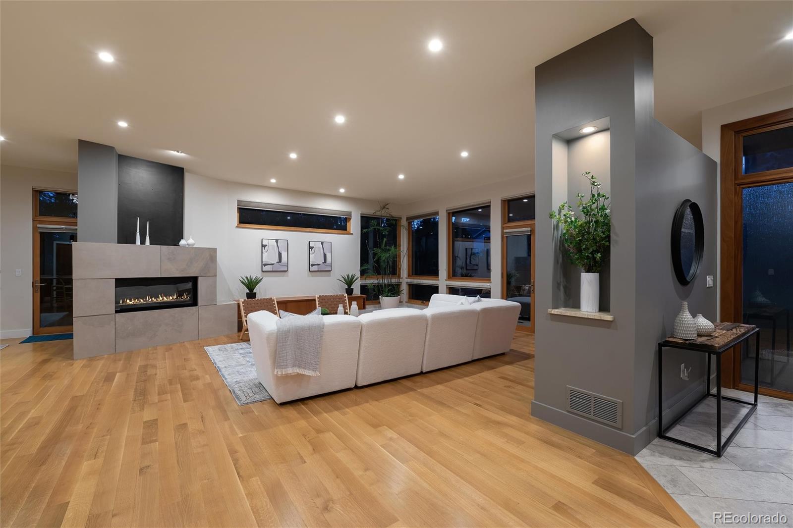 755 Jonquil Place Boulder, CO 80304 - Photo 6 of 40 a living room with furniture a fireplace a flat screen tv and a kitchen island