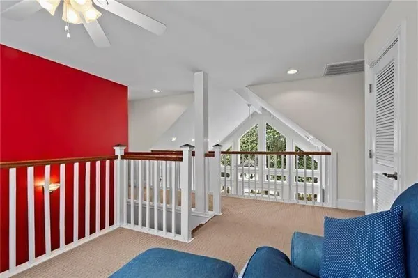 a spacious bedroom with a bed and a window