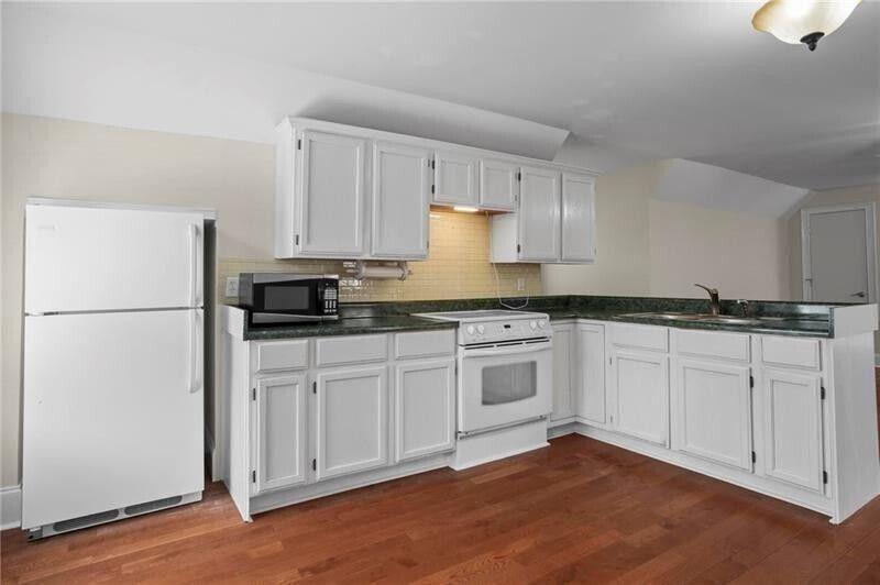 12 Rosalyn Road Georgetown, GA 39854 - Photo 61 of 82 a kitchen with granite countertop white cabinets and white appliances