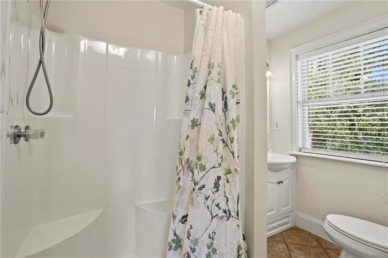 12 Rosalyn Road Georgetown, GA 39854 - Photo 65 of 82 a bathroom with a shower curtain a sink and a toilet
