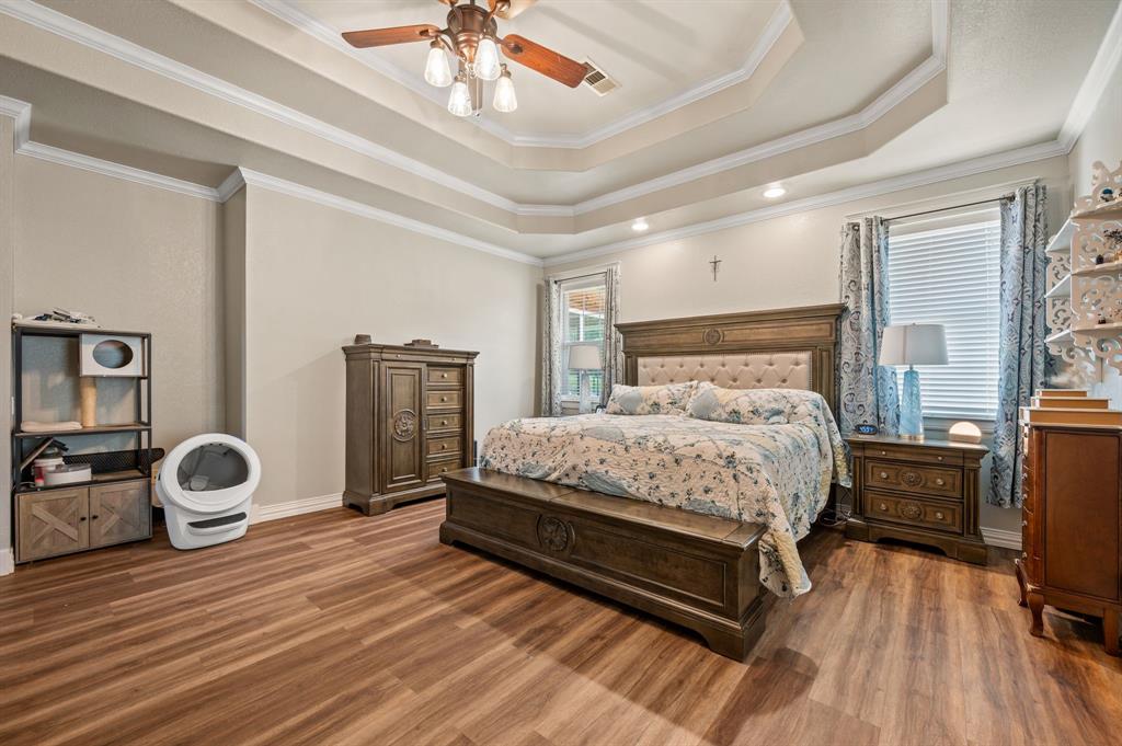 1216 W Road Waxahachie, TX 75165 - Photo 15 of 40 a bedroom with a bed and wooden floor