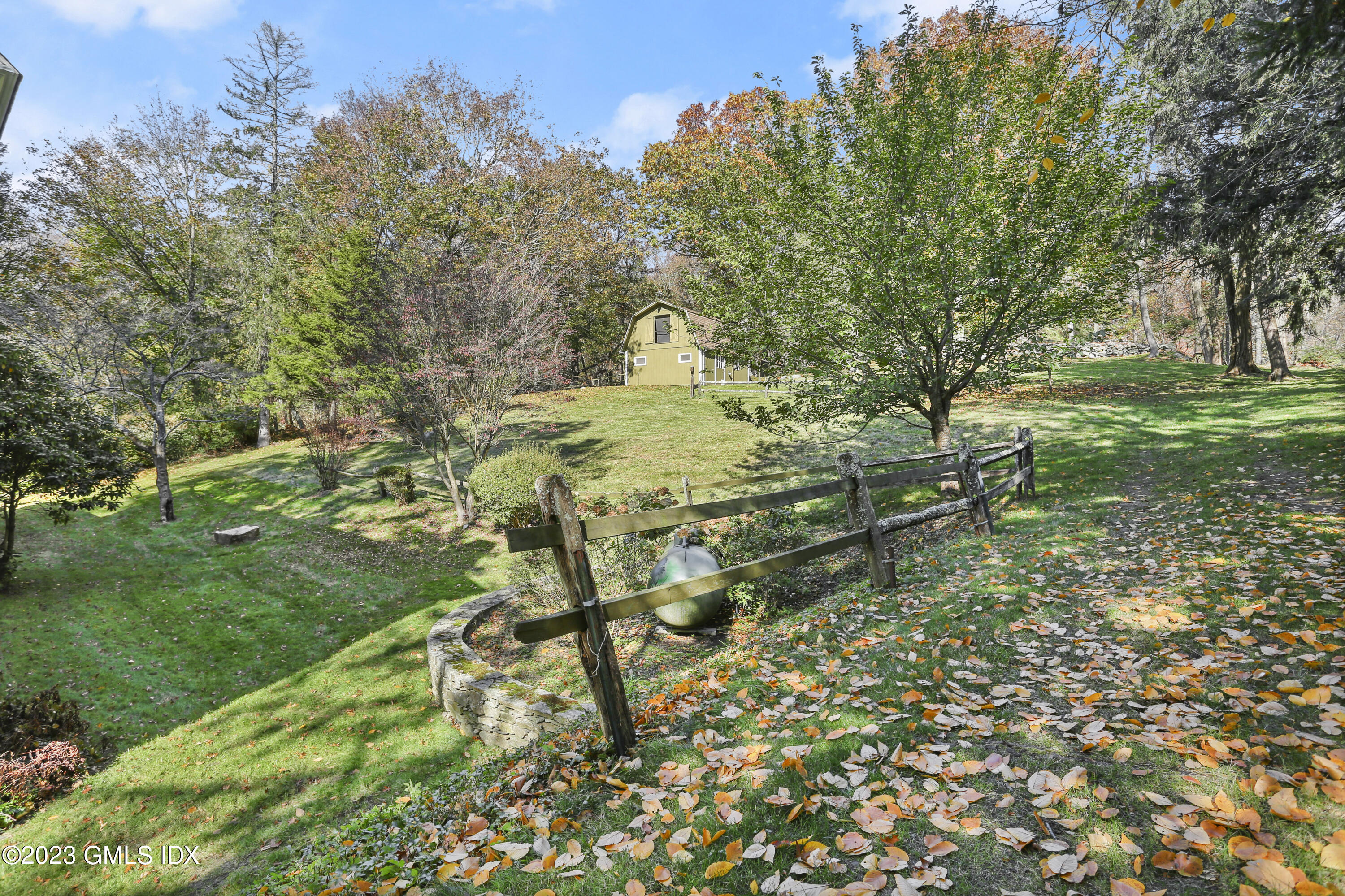 277 Riversville Road Greenwich, CT 06831 - Photo 18 of 23 a backyard of a house with table and chairs