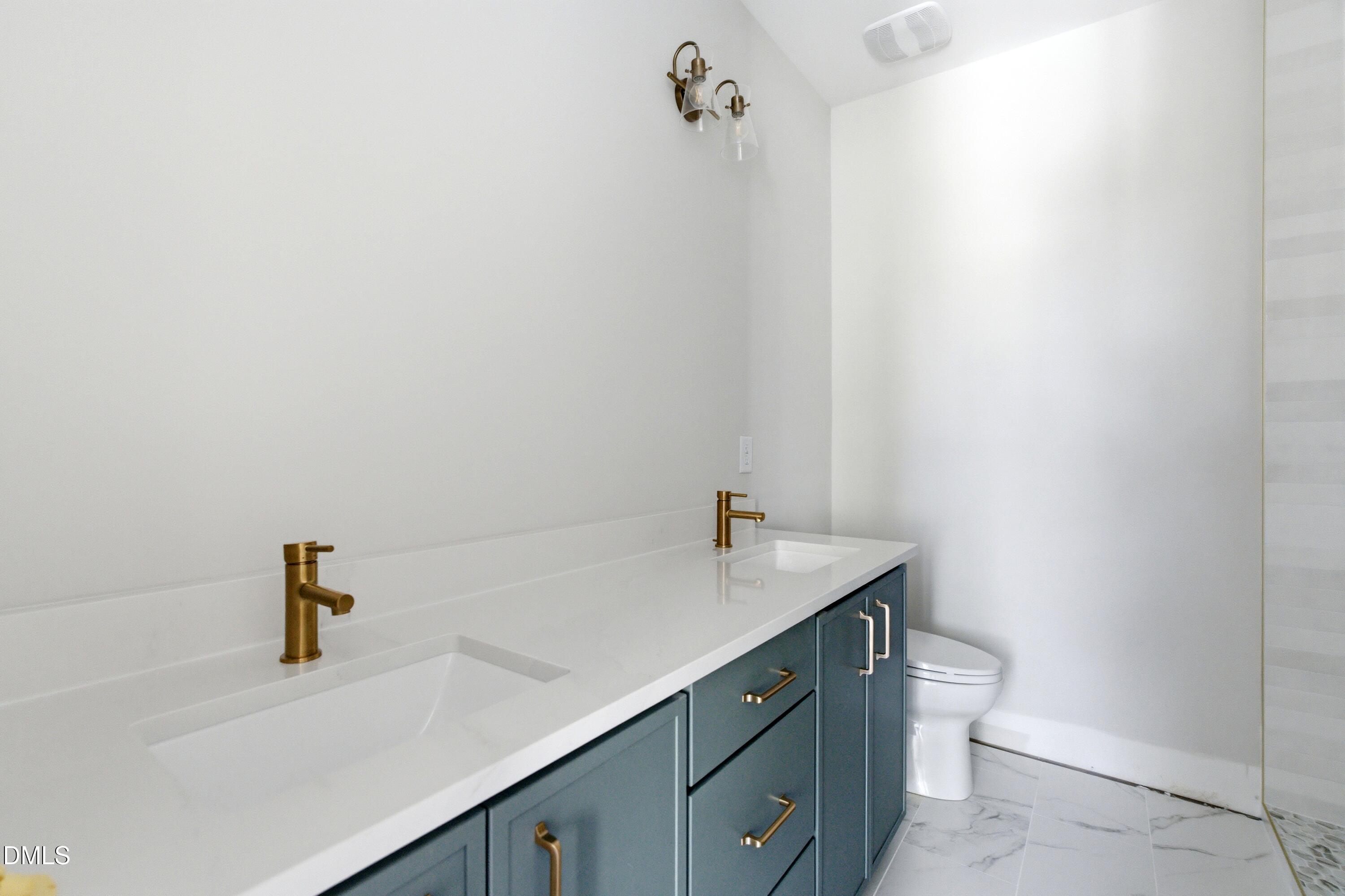 720 Noble Town Way, Unit 106 Raleigh, NC 27603 - Photo 13 of 28 a bathroom with a sink and a vanity