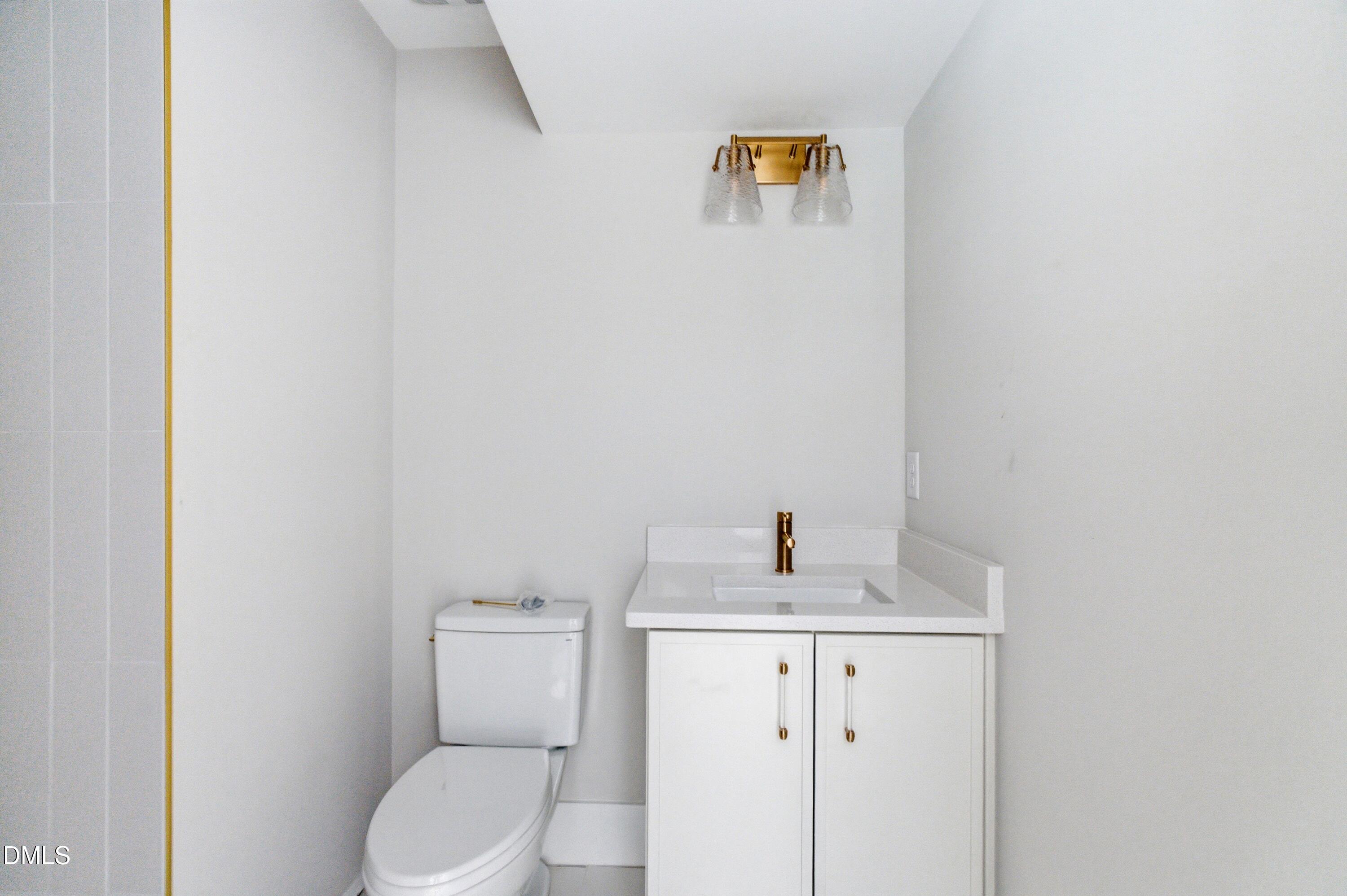720 Noble Town Way, Unit 106 Raleigh, NC 27603 - Photo 17 of 28 a bathroom with a toilet sink and vanity