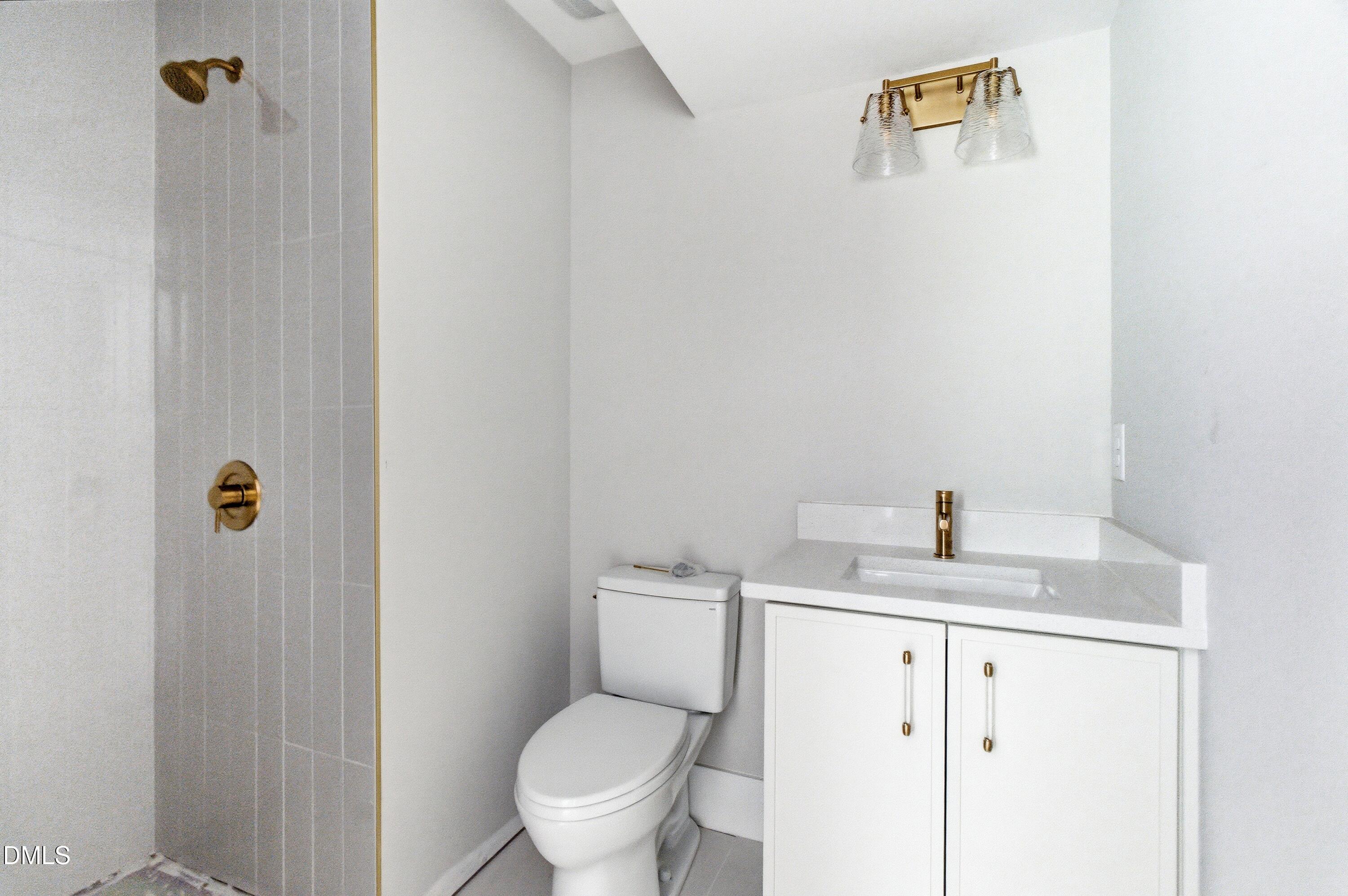 720 Noble Town Way, Unit 106 Raleigh, NC 27603 - Photo 20 of 28 a white toilet sitting next to a bathroom sink