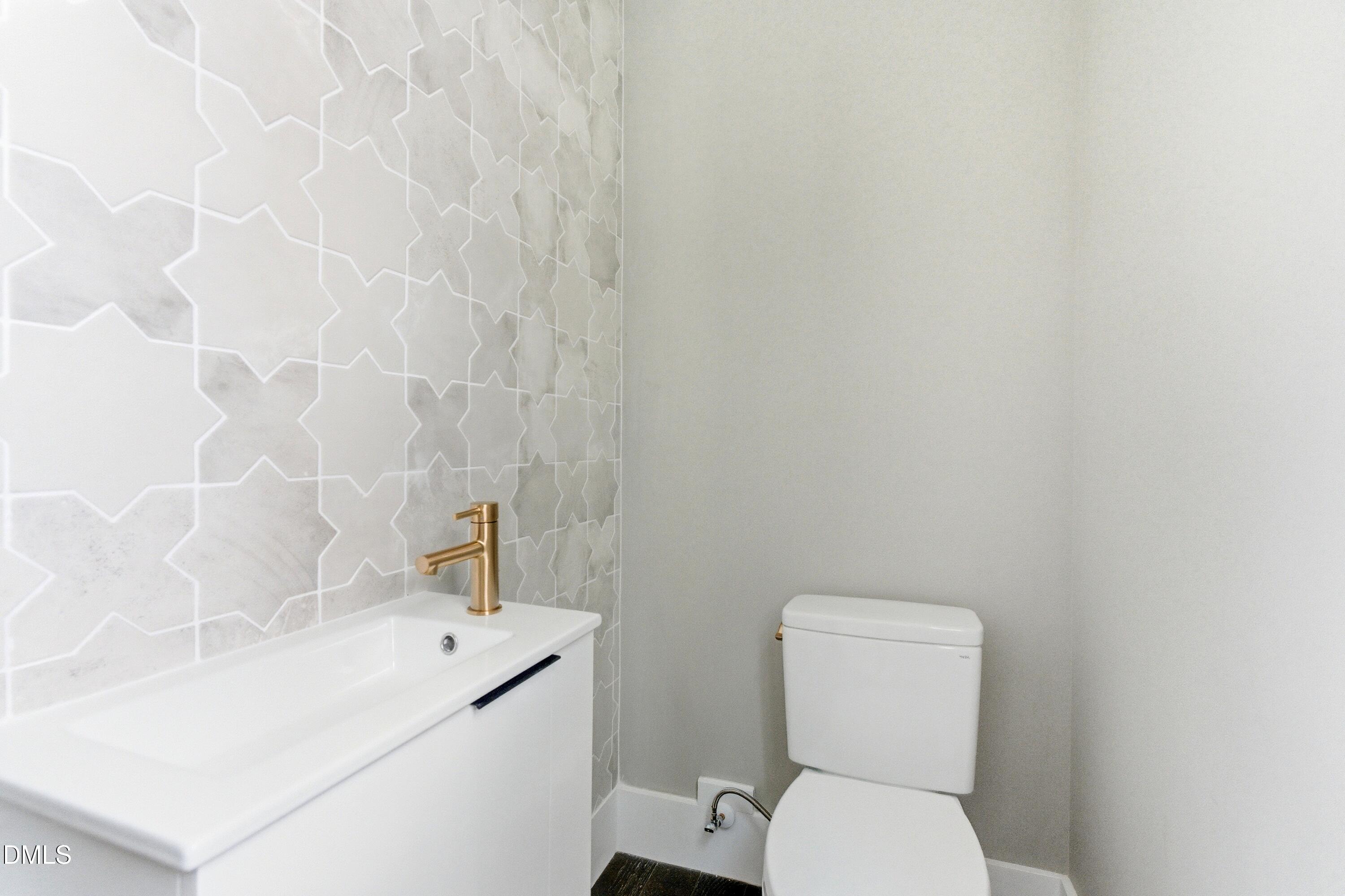 720 Noble Town Way, Unit 106 Raleigh, NC 27603 - Photo 21 of 28 a bathroom with a toilet sink and mirror