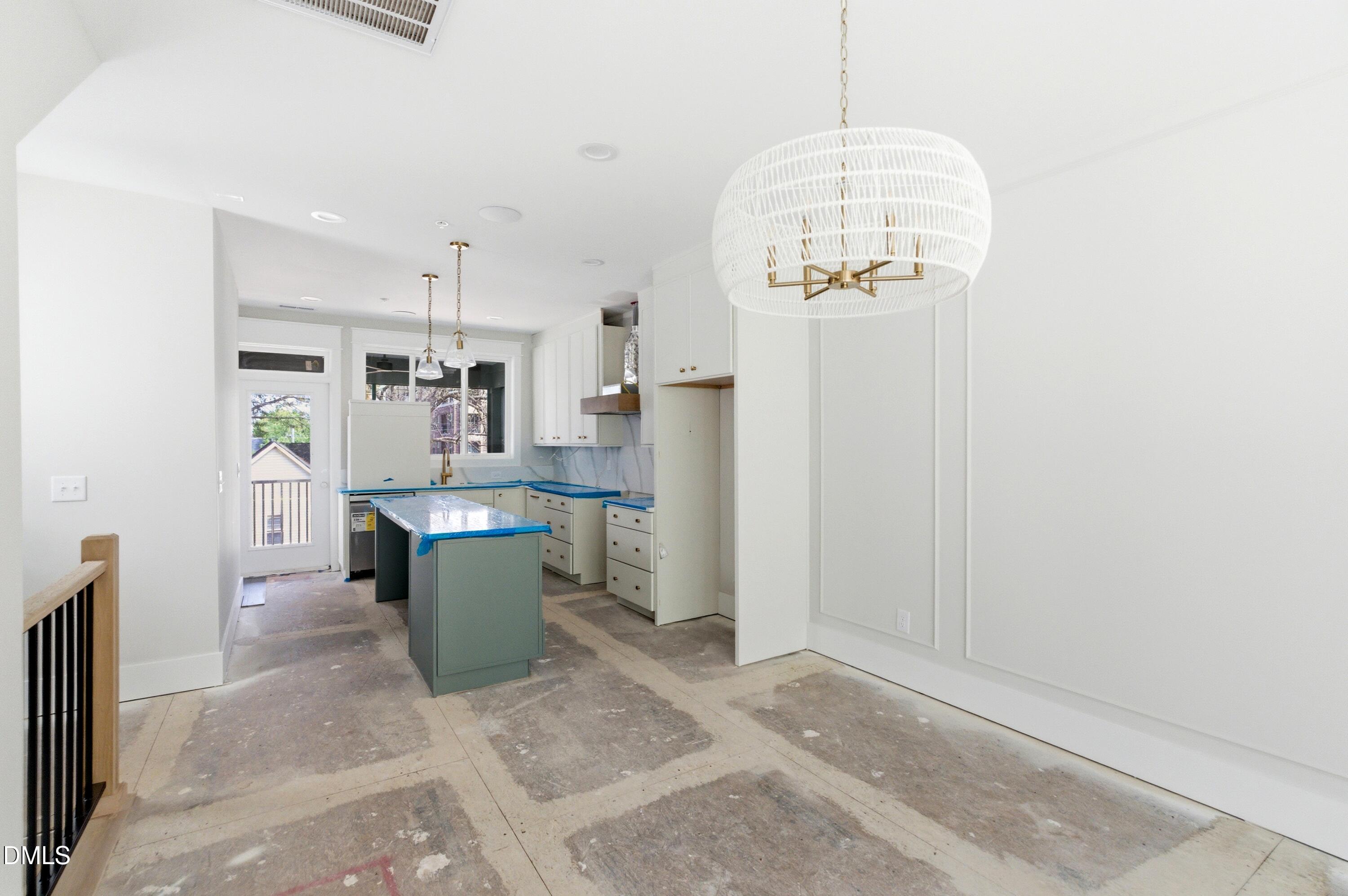 720 Noble Town Way, Unit 106 Raleigh, NC 27603 - Photo 6 of 28 a room with a chandelier furniture and kitchen view