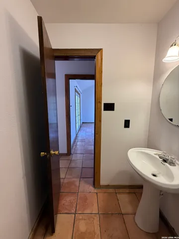 a bathroom with a sink a toilet and mirror