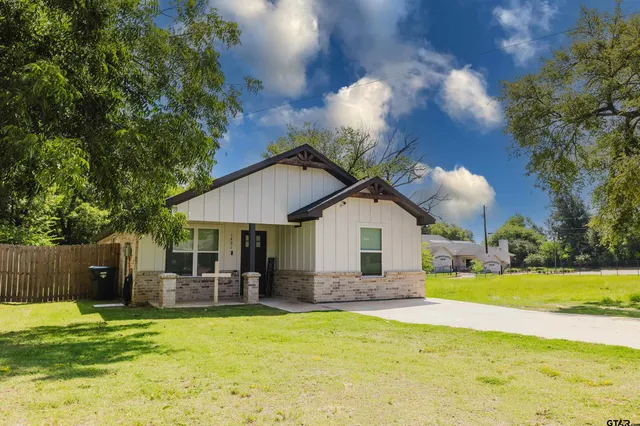 a view of a house with a yard patio and swimming pool